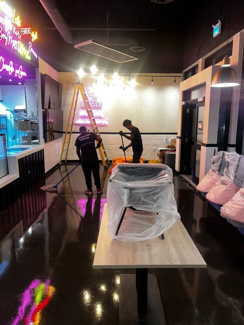 JJ Prime team deep cleaning a bar under neon lighting