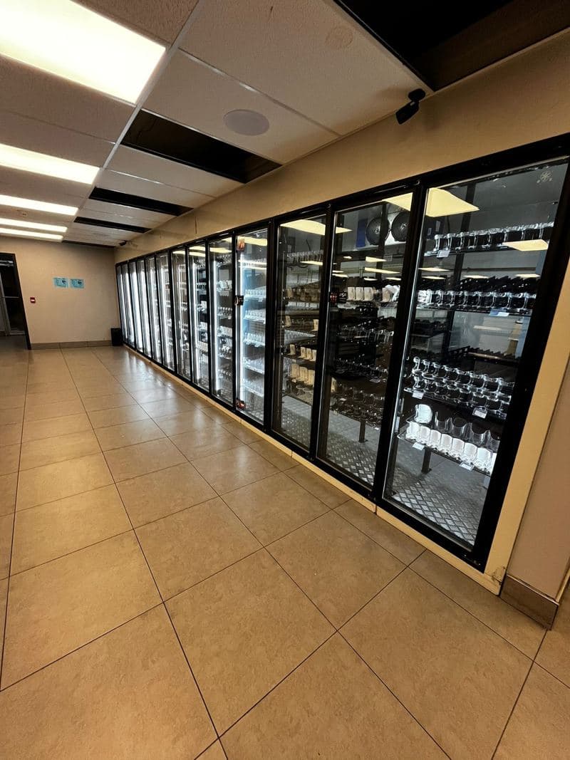 Row of glass chiller doors and a clean tiled shop floor