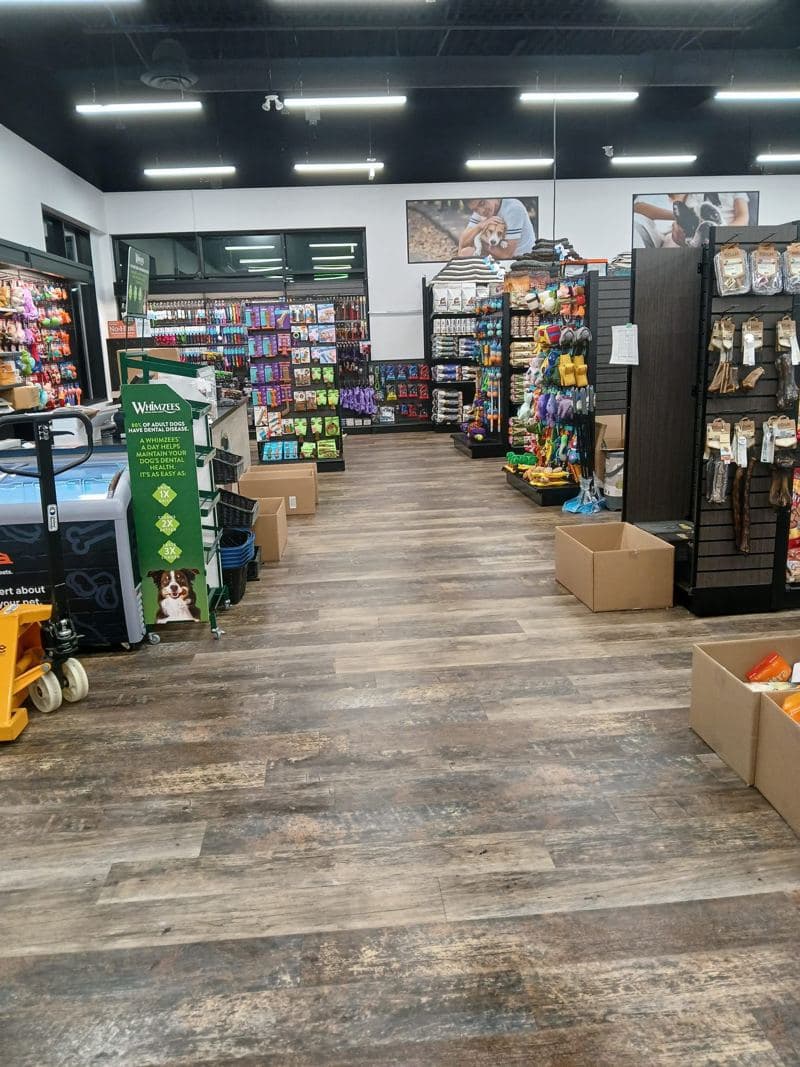 Convenience store aisles with a clean wood-effect floor