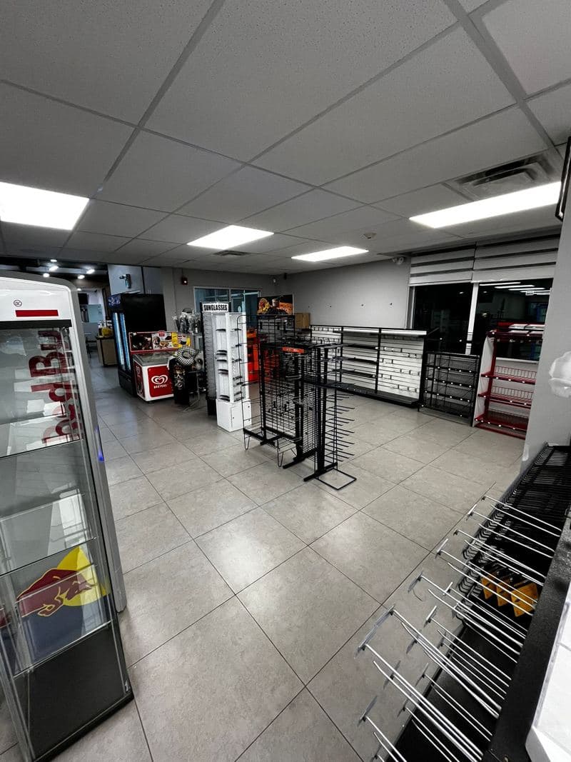 Convenience store with a freshly mopped tiled floor between the aisles