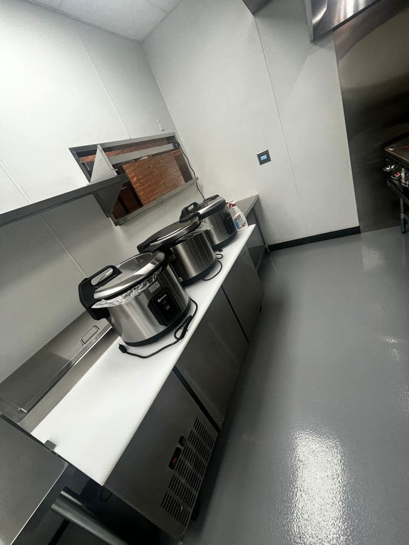 Stainless steel fryer line in a commercial kitchen after a deep clean