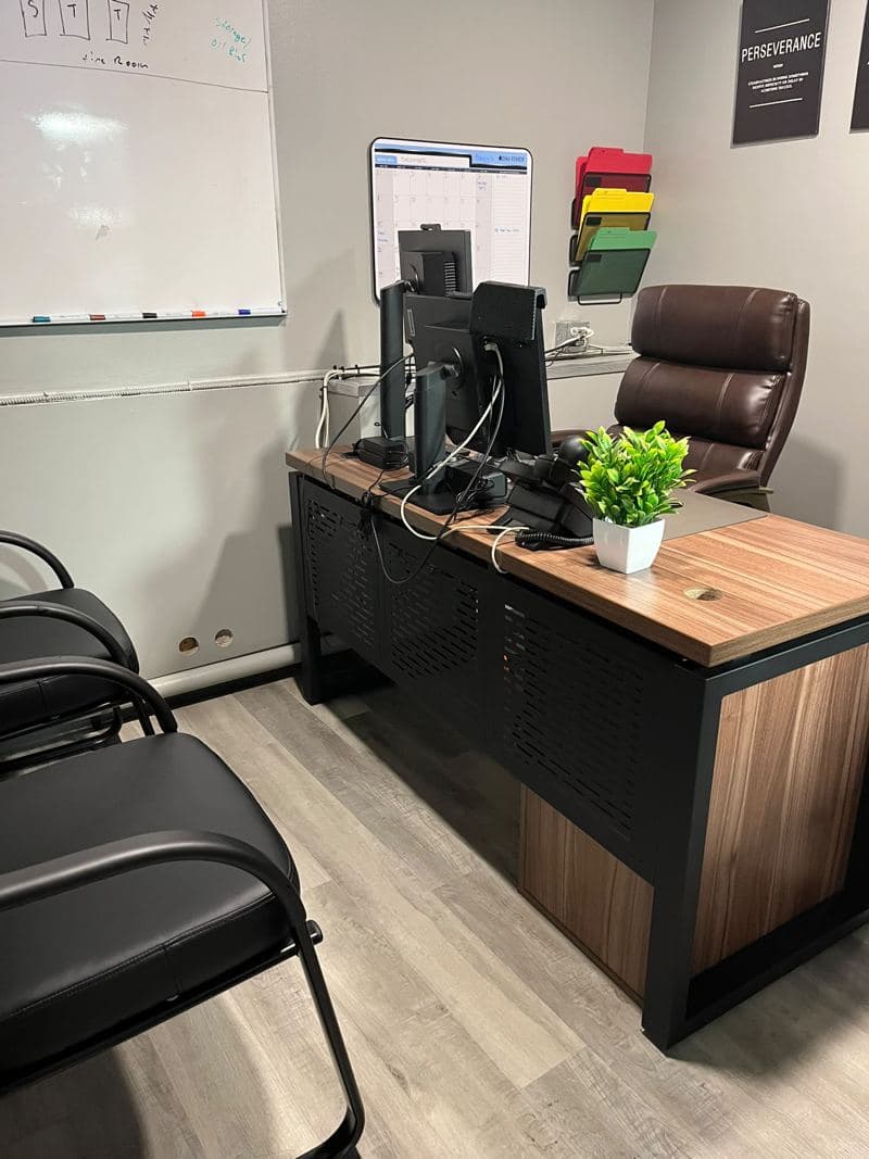 Manager office with a tidy desk, plant and wiped surfaces