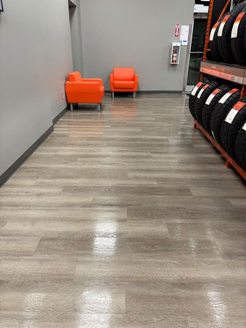Tyre showroom waiting area with orange chairs and a polished floor