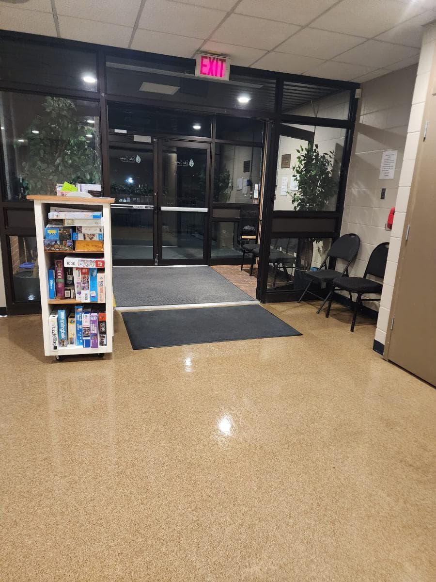 Building entrance lobby with a freshly polished floor, entrance matting and indoor plants