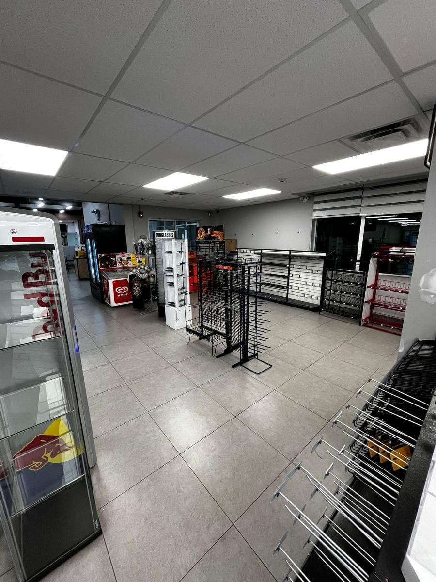 Retail unit with clean tiled flooring between shelving and display units