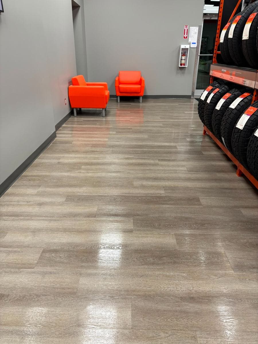Customer waiting area with orange armchairs on a freshly cleaned floor