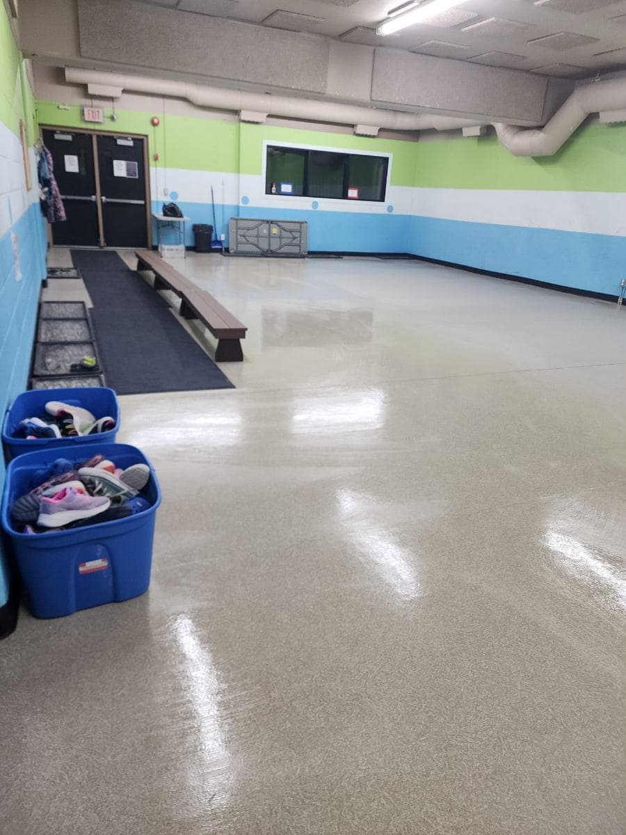Community room with tables and chairs set out on a clean floor