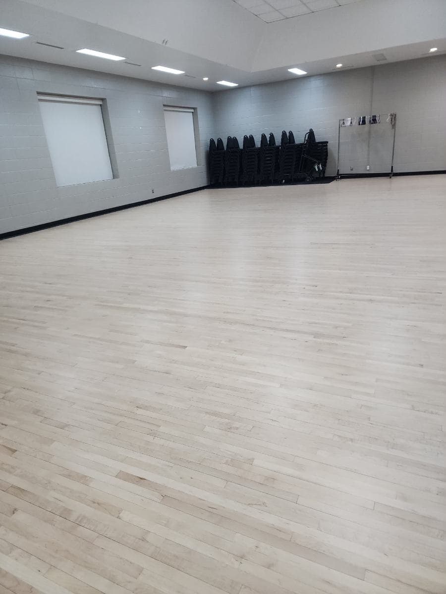 Function hall with rows of chairs set out on a clean floor