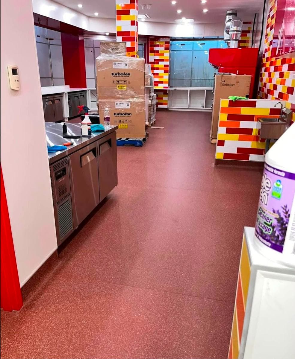 Bakery unit after a post-fit-out clean, with a glossy red resin floor