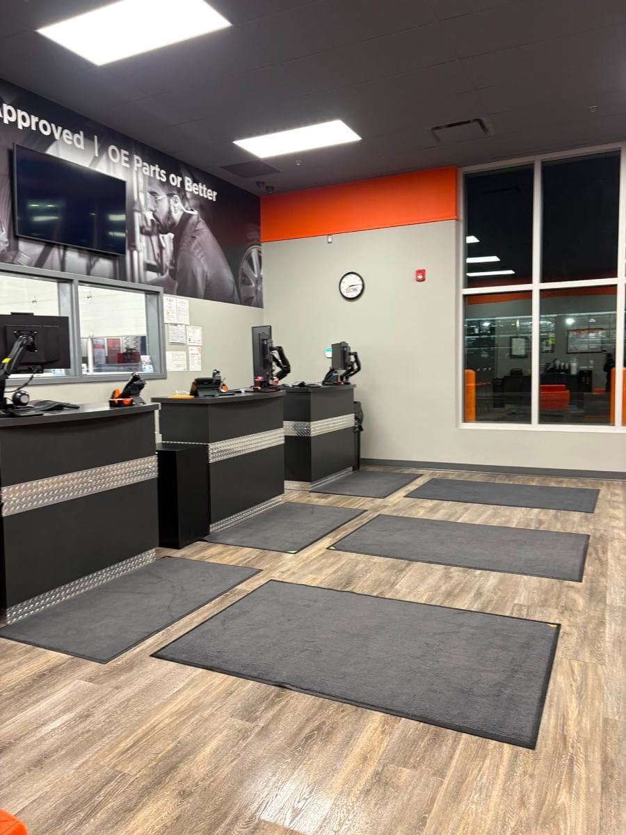 Service counters with clean entrance mats and a polished wood-effect floor